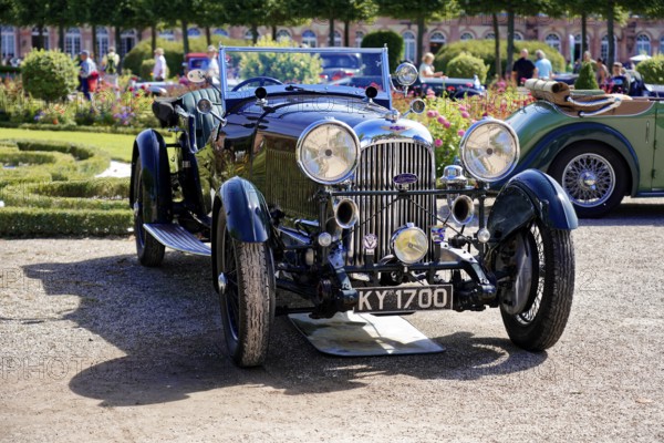 Lagonda, Oldtimer Classic, Gala International Concours d'Elegance Schwetzingen 2025, Germany, Europe, Black vintage car in retro style on an open road, surrounded by flowers