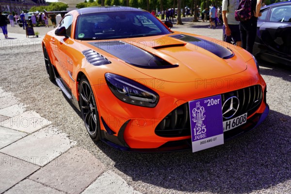 Oldtimer Classic, Gala International Concours d'Elegance Schwetzingen 2025, Germany, Europe, An orange sports car with a plaque celebrating a 125th anniversary