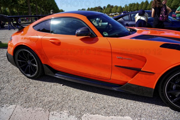 Oldtimer Classic, Gala International Concours d'Elegance Schwetzingen 2025, Germany, Europe, Side view of a modern orange sports car in sunny weather