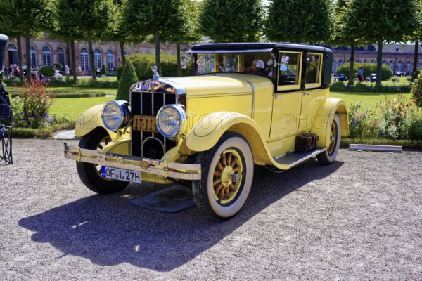 Oldtimer Classic, Gala International Concours d'Elegance Schwetzingen 2025, Germany, Europe, Yellow classic car with elegant lines and chrome accents on a sunny exhibition area