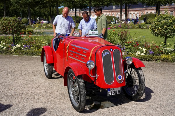BMW DIXI, year of construction 1928, Oldtimer Classic, Gala International Concours d'Elegance Schwetzingen 2025, Germany, Europe, Red racing car at an exhibition with spectators inspecting the vehicle