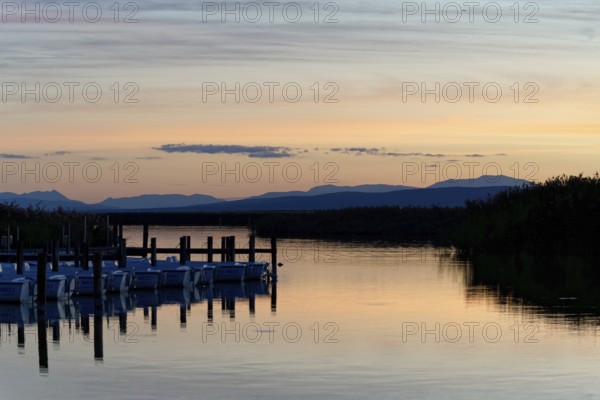 Lake Neusiedl, Burgenland, Austria, Europe, A lake at dusk with docked boats and soft colours, Sailboats on Lake Neusiedl