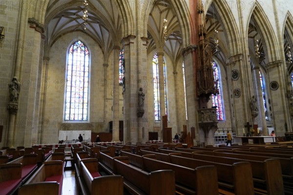 The interior of the largest Protestant church in Germany. It has the world's tallest church tower, Ulm Minster, Germany, Europe, Interior view of a Gothic church with tall columns and colourful stained glass windows, Ulm