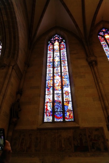 The interior of the largest Protestant church in Germany. It has the world's highest church tower, Ulm Minster, Germany, Europe, Illuminated Gothic church window with elaborate stained glass, Ulm