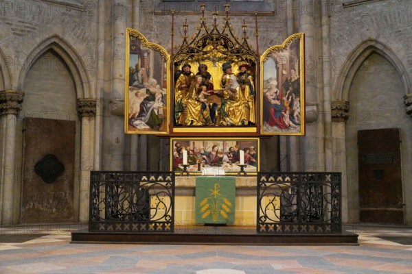 The interior of the largest Protestant church in Germany. It has the world's highest church tower, Ulm Minster, Germany, Europe, Altar with ornate paintings in a Gothic church interior, Ulm