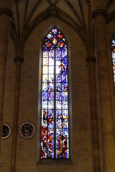 The interior of the largest Protestant church in Germany. It has the world's highest church tower, Ulm Minster, Germany, Europe, Gothic stained glass window with artistic colours and mystical atmosphere, Ulm