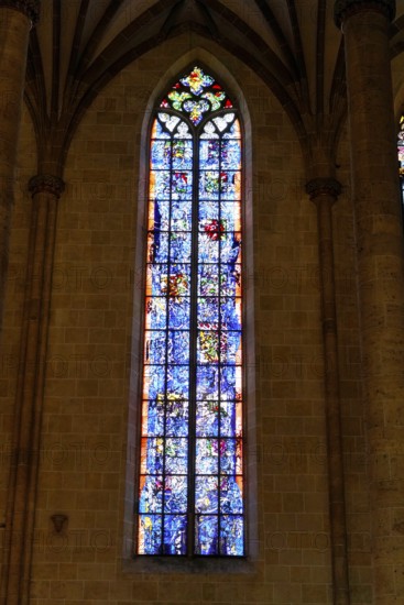 The interior of the largest Protestant church in Germany. It has the world's highest church tower, Ulm Minster, Germany, Europe, Colourful stained glass window with warm light in Gothic surroundings, Ulm