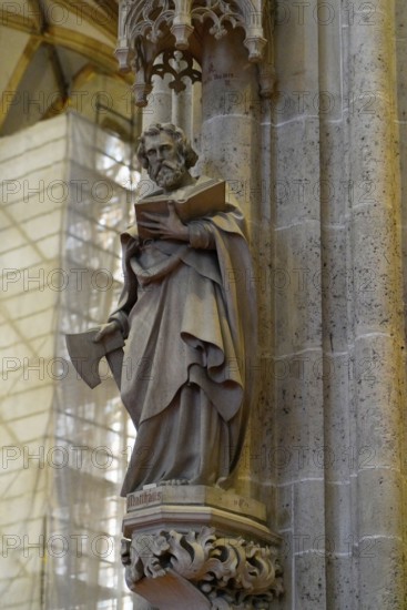 The interior of the largest Protestant church in Germany. It has the world's highest church tower, Ulm Minster, Germany, Europe, Stone statue of a saint with a book on a Gothic column, Ulm