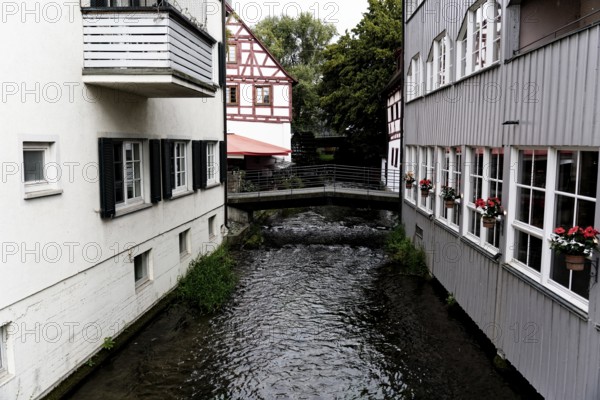 The picturesque fishermen's quarter in Ulm with its beautiful half-timbered houses on the Blau river, buildings with half-timbered houses and flowers, through which a small river flows, Ulm, Germany