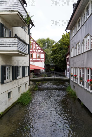 The picturesque fishermen's quarter in Ulm with its beautiful half-timbered houses on the Blau, a small river flowing between half-timbered houses in an idyllic old town, Ulm, Germany
