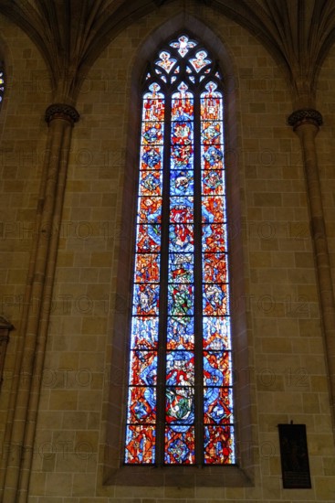 The interior of the largest Protestant church in Germany. It has the world's highest church tower, Ulm Minster, Germany, Europe, High, richly decorated stained glass window in a colourful design, Ulm