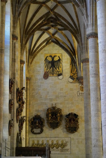 The interior of the largest Protestant church in Germany. It has the world's highest church tower, Ulm Minster, Germany, Europe, Interior view of a Gothic church with coats of arms on the walls, Ulm