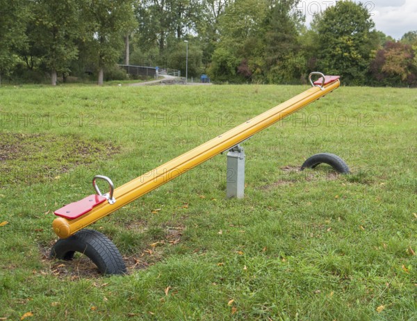 Outdoor playground scenery with Seesaw, lawn and trees