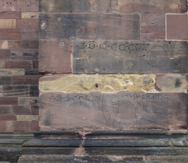 Historic engravings on a stone wall at the Freiburg Minster in Freiburg im Breisgau, a city in southern German