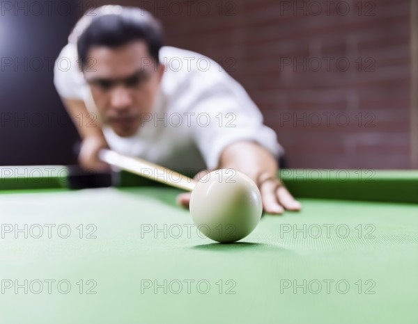 AI generated image showing a billiards table closeup with player and cue ball