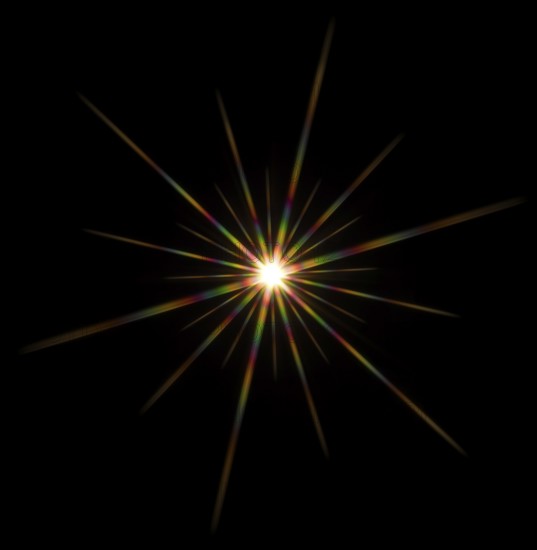 Colorful flashy spotlight star made with optical star filter on camera