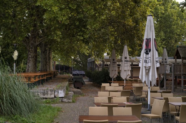 Beer garden on the Neckar, Neckar beer garden, empty, closed, Dinkelacker logo, Bad Cannstatt, Stuttgart, Baden-Württemberg, Germany