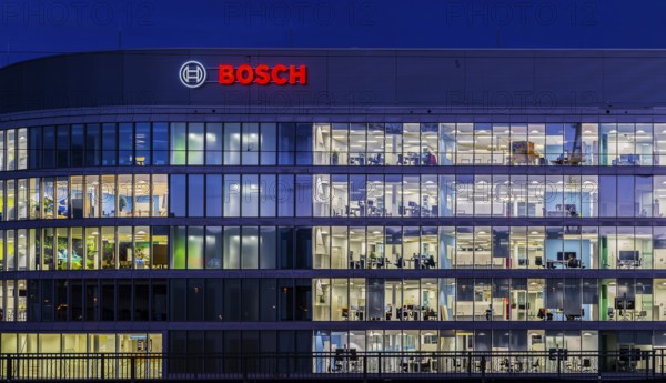 Modern office building of Bosch GmbH in Feuerbach at night with illuminated logo of the automotive supplier. Bosch Digital, Bosch IT Campus, Building 701, Stuttgart, Baden-Württemberg, Germany
