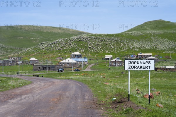 A country road leads to the village of Zorakert, surrounded by green hills and nature, Zorakert, Lake Arpi, Shirak Province, Armenia