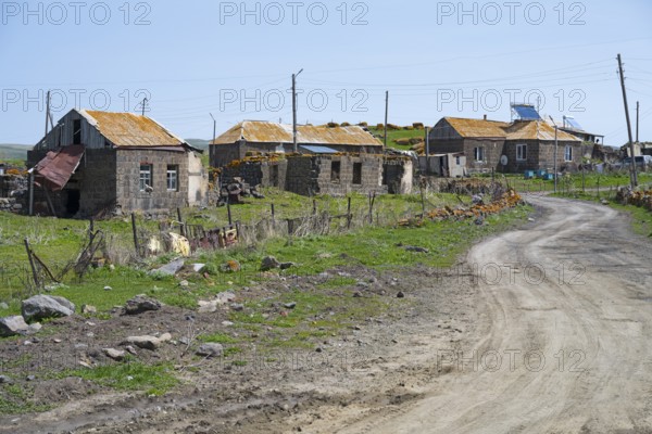 Quiet village with old buildings along a dirt road in a green landscape, Berdashen, Lake Arpi, Shirak Province, Armenia