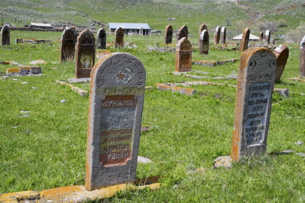 Close-up of two gravestones in a grassy cemetery with rolling hills in the background, old cemetery, Aghvorik, Shirak province, Armenia