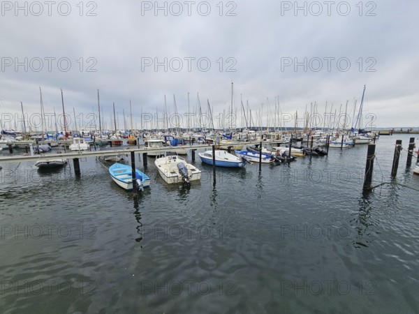 Expansive view of numerous boats in the harbour, surrounded by water and a cloudy sky, Laboe, Kiel Fjord, Schleswig-Holstein, Germany