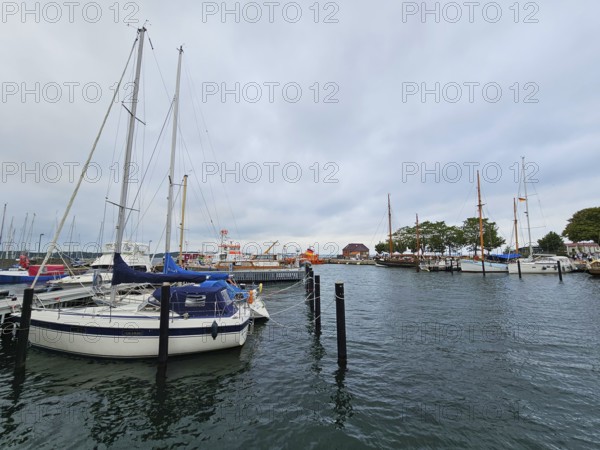 Sailboats and yachts in the harbour under a grey sky, surrounded by water and harbour structures, Laboe, Kiel Fjord, Schleswig-Holstein, Germany