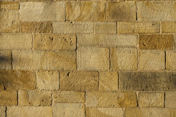 Yellow sandstone wall, sandstone wall, background, texture, Münsterland, North Rhine-Westphalia, Germany
