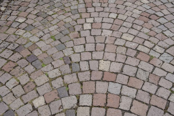 Floor covering made of paving stones with an arched pattern in grey and reddish tones, background, texture, Germany