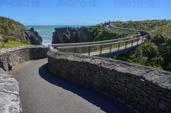 Extensive stone paths lead over a bridge past cliffs overlooking the sea, Pancake Rocks, Westport, Greymouth, West Coast, South Island, New Zealand
