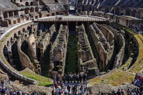 View of uncovered hypogeum substructure of Arena of Colosseum from the time of Emperor Domitian, at the top of the picture ancient east gate of Amphitheatrum Flavium so-called gate of the gladiators Porta della Vita entrance for gladiators direct access to Arena, in front of it partially restored wooden floor of Arena, Colosseum, Rome, Latium, Italy