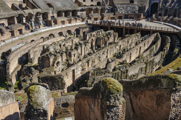 View of uncovered hypogeum substructure of Arena of Colosseum from the time of Emperor Domitian, top right at the edge of the picture ancient east gate of Amphitheatrum Flavium so-called Gate of the Gladiators Porta della Vita entrance for gladiators direct access to Arena, in front of it partially restored wooden floor of Arena, Colosseum, Rome, Latium, Italy