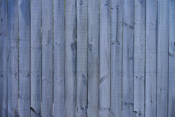 Close-up of a grey wooden fence with vertical panels and distinct texture, West Coast, South Island, New Zealand