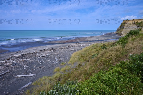 Wide coastal view with imposing cliffs, calm sea and cloudy sky, Mana Bay, Riverview Lookout, Patea, Taranaki, North Island, New Zealand