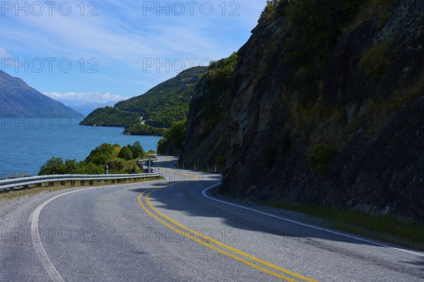 Winding road leads through remote landscape along a lake, Devil's Staircase Lookout Point, Kingston, Lake Wakatipu, Queenstown-Lakes District, Otago, South Island, New Zealand