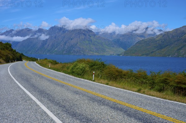 Winding road along a lake with mountains in the background, Devil's Staircase Lookout Point, Kingston, Lake Wakatipu, Queenstown-Lakes District, Otago, South Island, New Zealand
