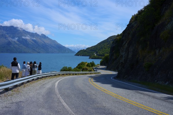 Travellers enjoy the view of the lake and mountains, Devil's Staircase Lookout Point, Kingston, Lake Wakatipu, Queenstown-Lakes District, Otago, South Island, New Zealand