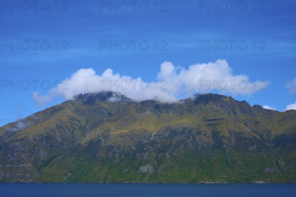 Majestic mountains with clouds against a clear blue sky, Devil's Staircase Lookout Point, Kingston, Lake Wakatipu, Queenstown-Lakes District, Otago, South Island, New Zealand