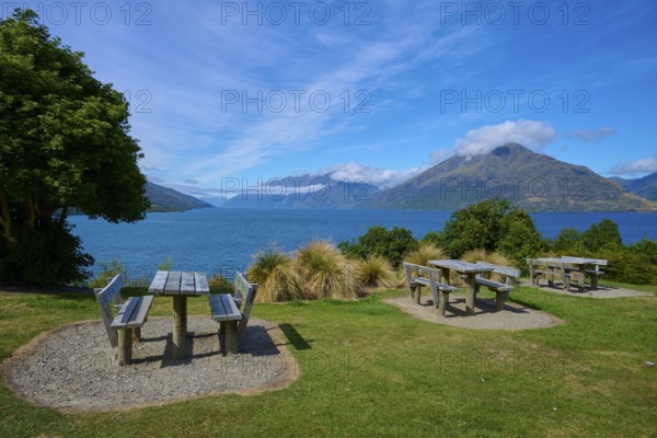Picnic tables with a view of a lake and mountains below, Drift Bay, Lake Wakatipu, Queenstown-Lakes District, Otago, South Island, New Zealand