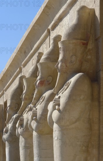 Architectural detail of the Mortuary Temple of Hatshepsut in Egypt with stone sculptures in a row