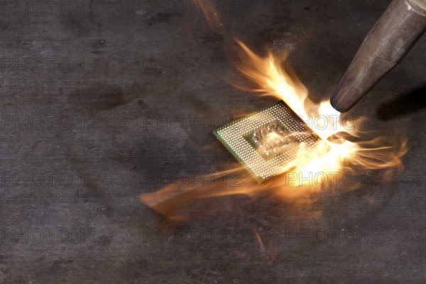 CPU and welding torch with big flame on metallic ground