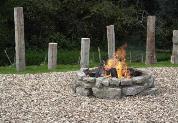 Outdoor fireplace with burning fire