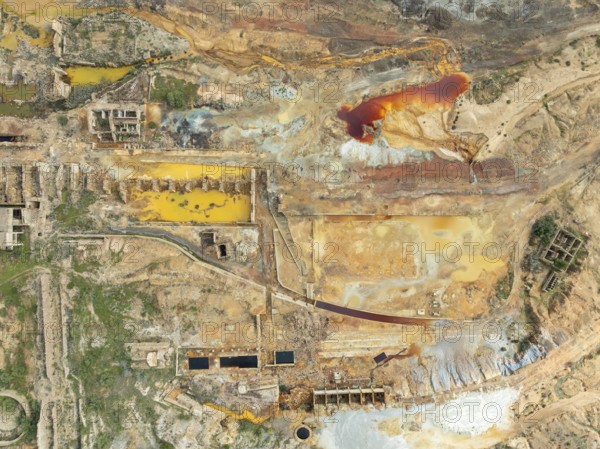 Old mining site and deep orange-red hues in the water of a pool in the mineral-rich area of the Rio Tinto mines. The colour is caused by oxidised iron minerals. Aerial view. Drone shot. Huelva province, Andalusia, Spain