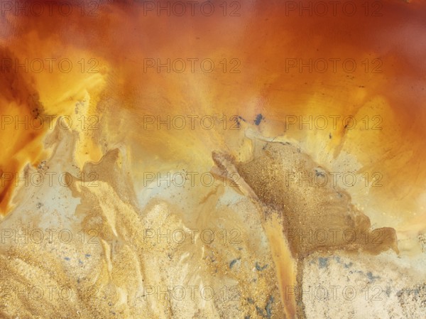 Abstract patterns in a pool in the mineral-rich area of the Rio Tinto mines. The colour is caused by oxidised iron minerals. Aerial view. Drone shot. Huelva province, Andalusia, Spain