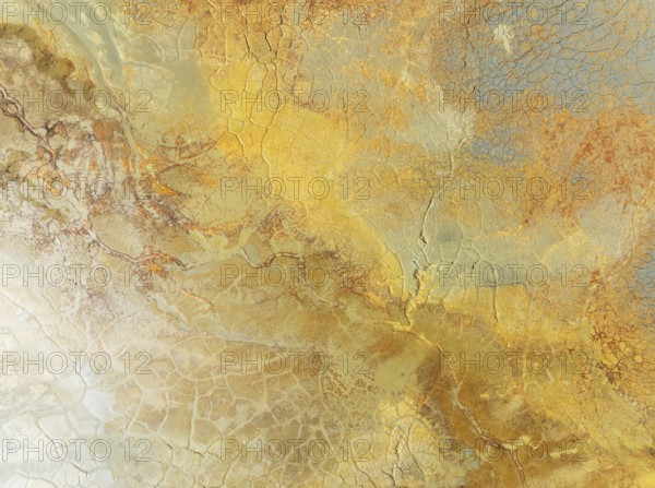 Abstract patterns in a waste pond in the mineral-rich area of the Rio Tinto mines. The colour is caused by oxidised iron minerals. Aerial view. Drone shot. Huelva province, Andalusia, Spain