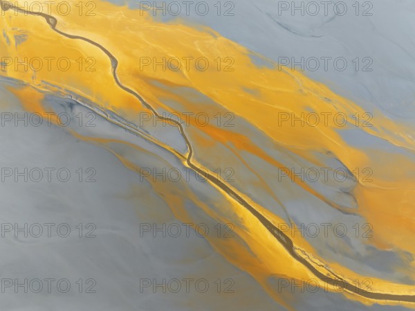 Abstract patterns in a waste pond in the mineral-rich area of the Rio Tinto mines. The colour is caused by oxidised iron minerals. Aerial view. Drone shot. Huelva province, Andalusia, Spain