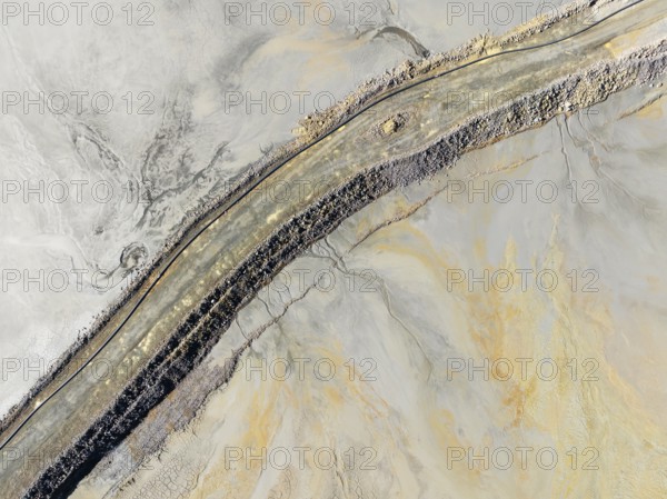 Causeway at a waste pond in the mineral-rich area of the Rio Tinto mines. Aerial view. Drone shot. Huelva province, Andalusia, Spain