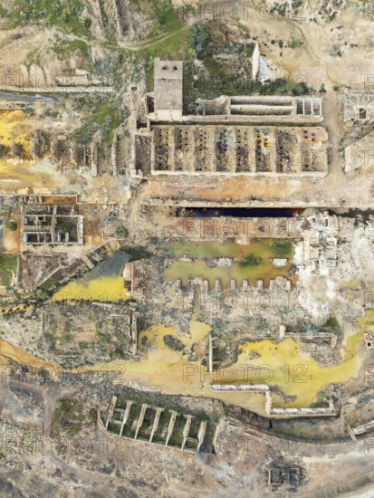 Old mining site and deep orange-red hues in the water of a pool in the mineral-rich area of the Rio Tinto mines. The colour is caused by oxidised iron minerals. Aerial view. Drone shot. Huelva province, Andalusia, Spain