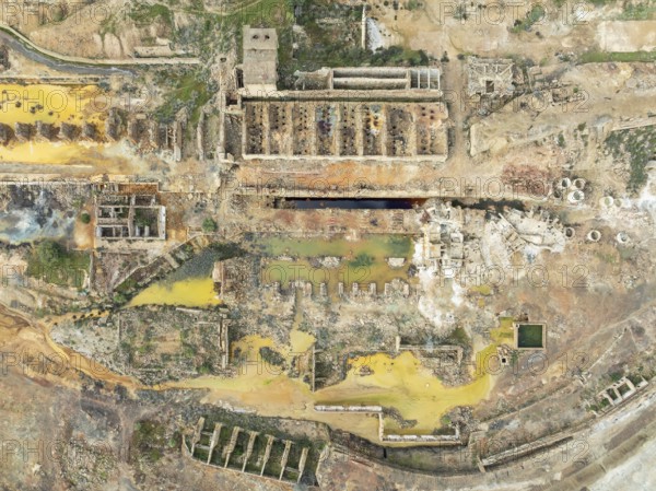 Old mining site and deep orange-red hues in the water of a pool in the mineral-rich area of the Rio Tinto mines. The colour is caused by oxidised iron minerals. Aerial view. Drone shot. Huelva province, Andalusia, Spain