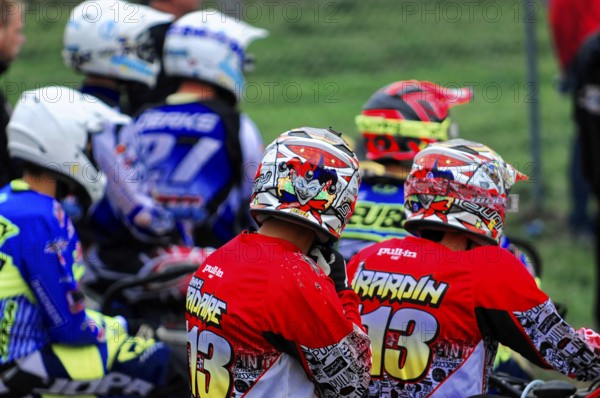 Motocross, Rudersberg, Baden-Württemberg, Germany, Europe, Motorcyclists in colourful clothing and helmets sit side by side, ready for the start, Rudersberg Motocross
